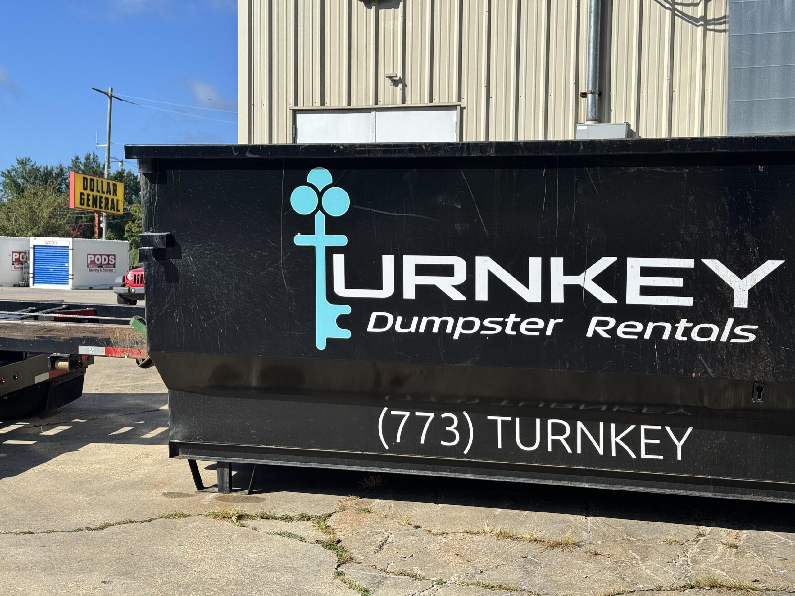 Turnkey Operations branded roll-off dumpster on a job site in Brookhaven MS